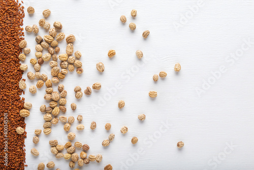 Watercress and nasturtium seeds on white textured background. Top view. © Grigoriy