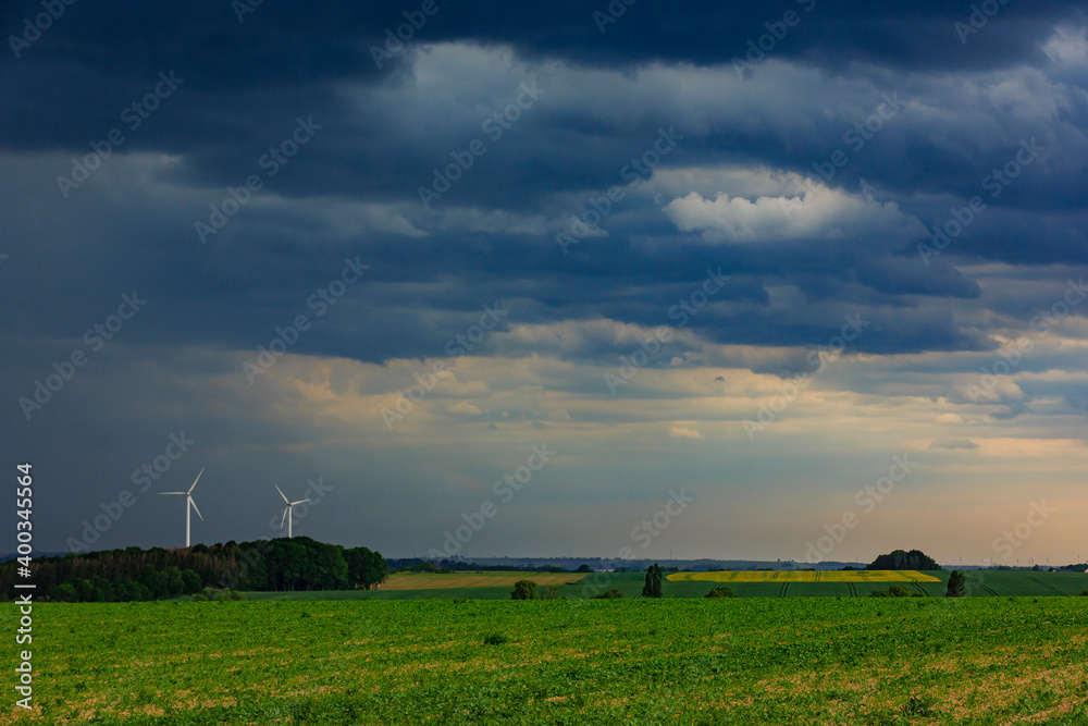 a storm is coming above a bunch of wind mills, Lausitz, Saxony