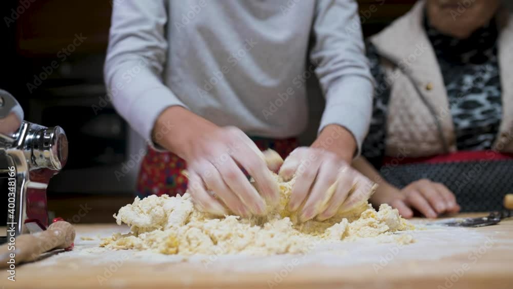 Crop woman preparing dough at table in kitchen Crop woman preparing dough at table in kitchen