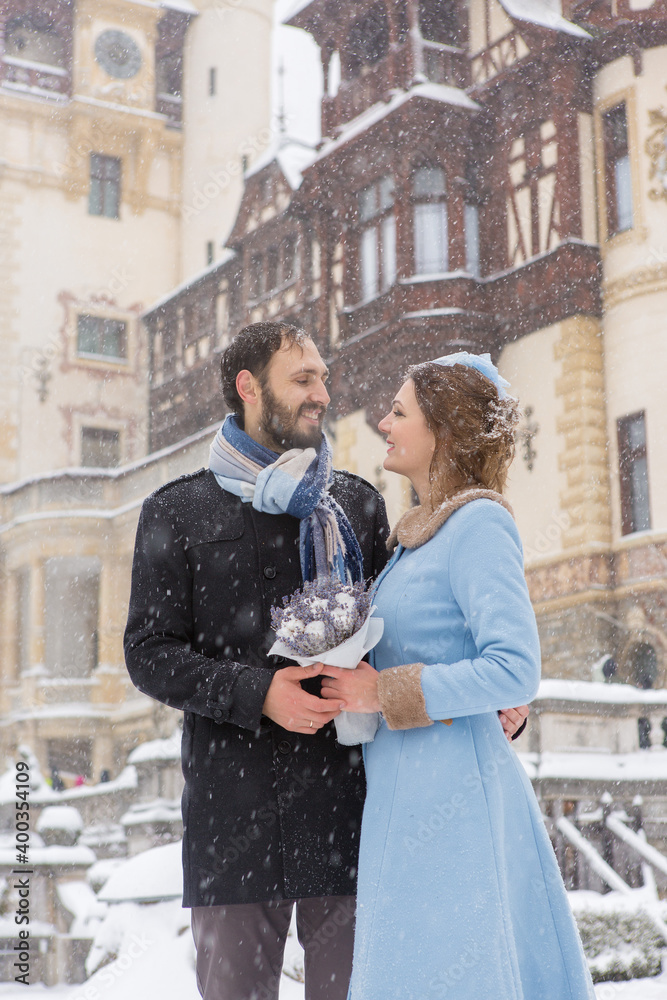 Happy Young Couple in Winter Park. Family outdoors at the castle.