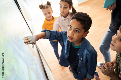 Boy looking at the interactive whiteboard with eyes wide open