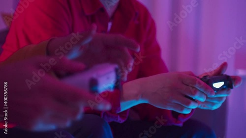Excited friends father and son playing online video games on modern console next gen 2020, new era of consoles, white gamepad, man group at home play games
