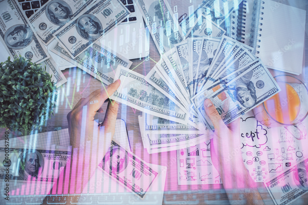 Multi exposure of financial graph drawing hologram and USA dollars bills and man hands. Analysis concept. Multi exposure of financial graph drawing hologram and USA dollars bills and man hands. Analysis concept.