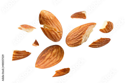 Foto almonds baked pieces snack  and cracks Spread out  on white isolated