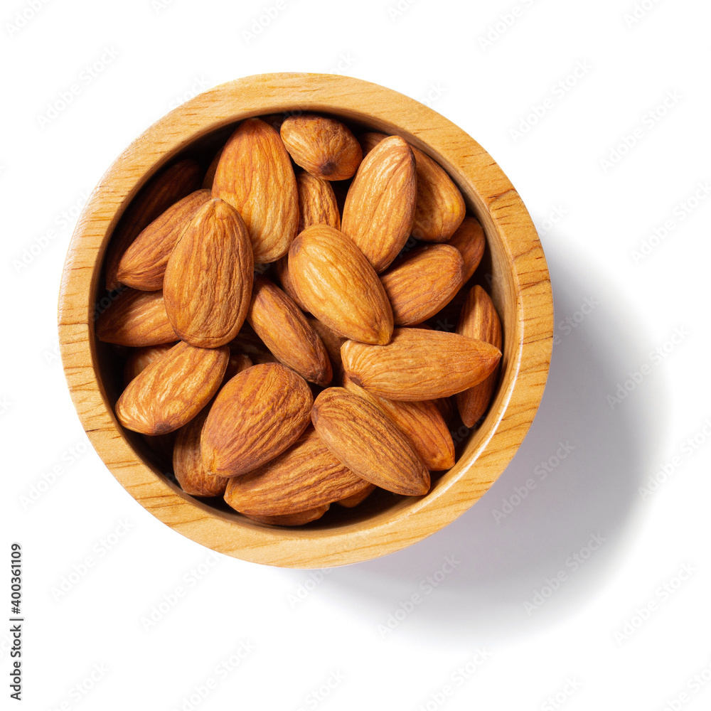 Almond in a wooden cup top view long shadow Almond in a wooden cup top view long shadow