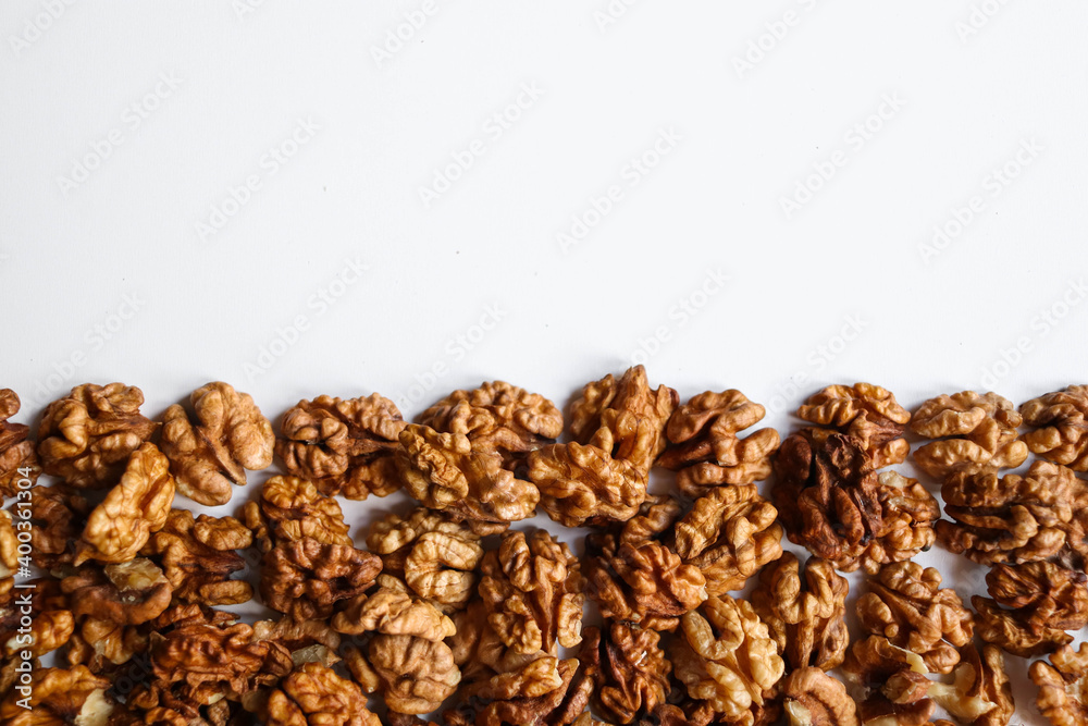 Top view of peeled walnuts placed on a white Top view of peeled walnuts placed on a white