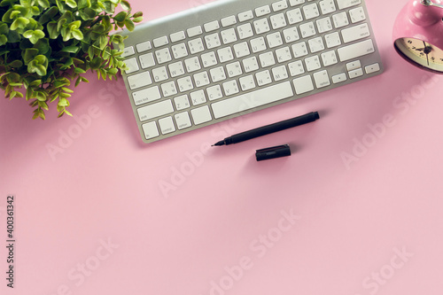Modern pink office desk table with smartphone and other supplies eye glasses and cup of coffee,.for input the text in the middle. Top view, flat lay.