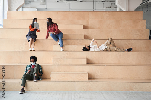 Group of friend or students smile happily while sitting at the stairs