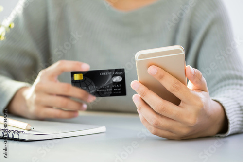 Young woman paying by credit card close up Hands holding credit card Online shopping