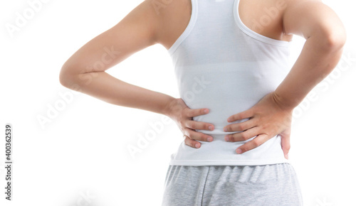 Woman holding her lower back in pain on white isolated © SizeSquare's