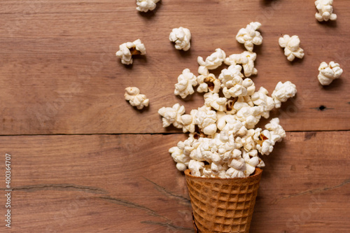 snack popcorn with ice cream Cone on wood background