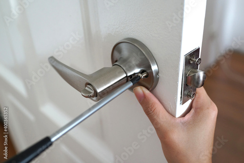 Handyman install the new door lock in the room