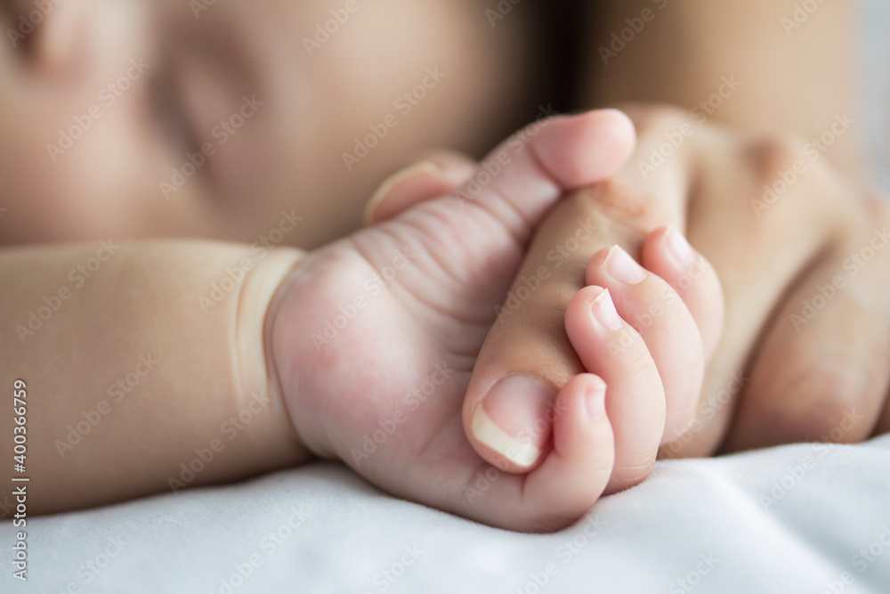 hand the sleeping baby in the hand of mother close-up hand the sleeping baby in the hand of mother close-up