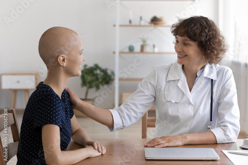 Photography Happy female cancer patient tell she is feeling better to trusted doctor on appointment at hospital
