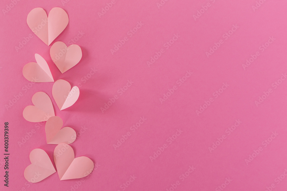 Paper pastel pink hearts on a pink background. the concept of romance, love and tenderness. Bright greeting card for Valentine's Day. Design of the anniversary of mother's Day. The view from the top.
