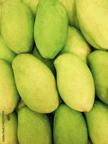 Wallpaper Mural Close up pile of Thai green mangoes, top view green mango, vertical image. Torontodigital.ca
