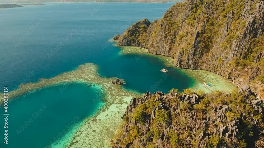 Aerial seascape tropical lagoon with azure water and coral reef among rocks with tropical vegetation, Palawan, Philippines Travel concept, Aerial footage. Aerial seascape tropical lagoon with azure water and coral reef among rocks with tropical vegetation, Palawan, Philippines Travel concept, Aerial footage.