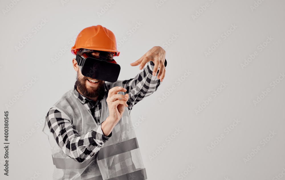 a construction worker in an orange helmet and 3D glasses gestures with his hands Copy Space a construction worker in an orange helmet and 3D glasses gestures with his hands Copy Space