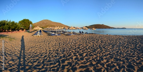 Sunset at Plati beach, Limnos, Greece. Sandy beach, footprints in the sand, calm sea, sunset. photo