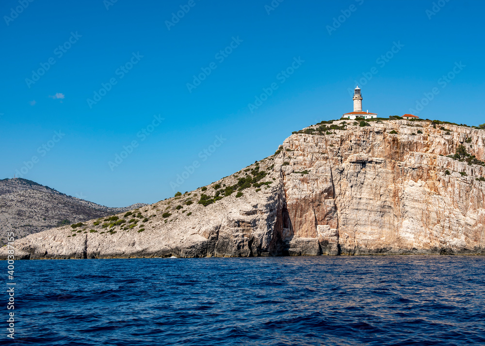 Lighthouse on a rocky island in the Adriatic sea off the coast of Croatia