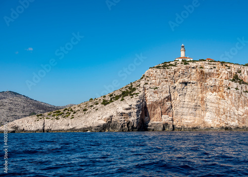 Lighthouse on a rocky island in the Adriatic sea off the coast of Croatia © Sergey