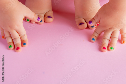 Close-up of kids painted nails on hands and feet  flat lay and copy space