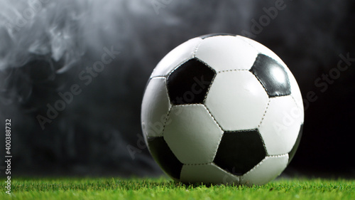 Soccer ball on lawn with smoke