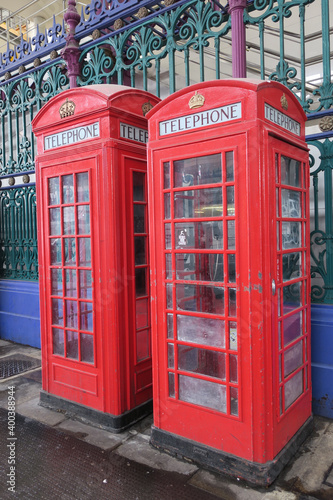 two red telephone booths on the smith market in London