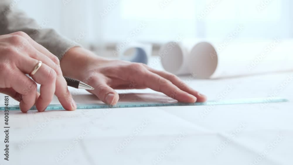 Close-up of an architect's hands. Professional real estate designer at the workplace in the office. Close-up of an architect's hands. Professional real estate designer at the workplace in the office.