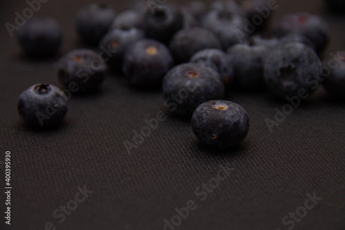 dark blue blueberries on a dark background