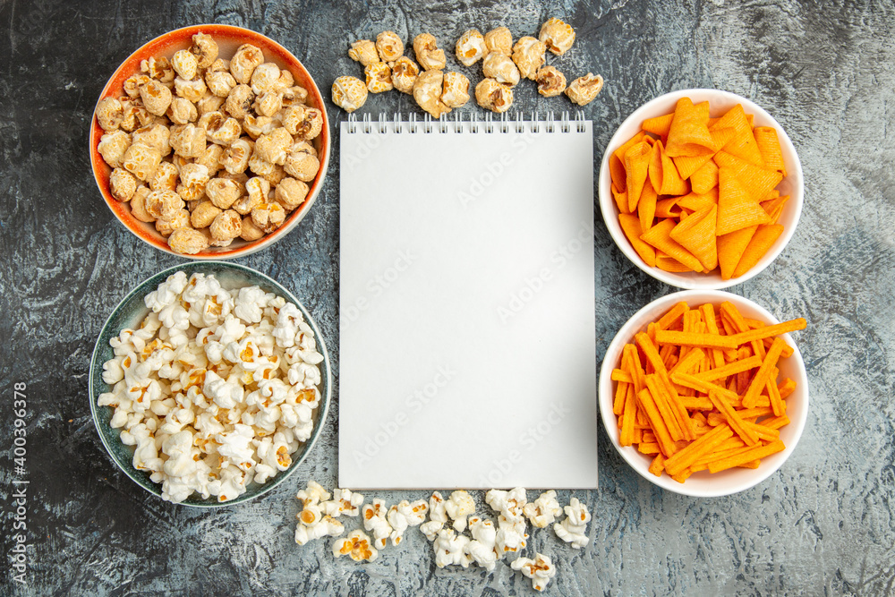 top view different snacks popcorn rusks and cips on light floor snack movie cinema top view different snacks popcorn rusks and cips on light floor snack movie cinema