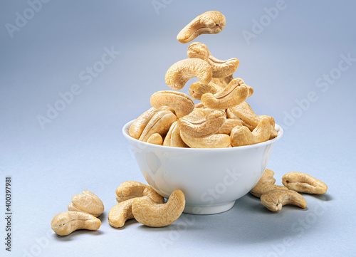 Cashew nuts into bowl with copy space photo