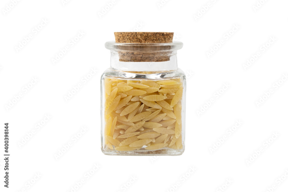 In Greece called kritharaki. In Italy called Orzo. Rice shaped pasta in a glass jar isolated on white background. Type of pasta. Food ingredient. In Greece called kritharaki. In Italy called Orzo. Rice shaped pasta in a glass jar isolated on white background. Type of pasta. Food ingredient.