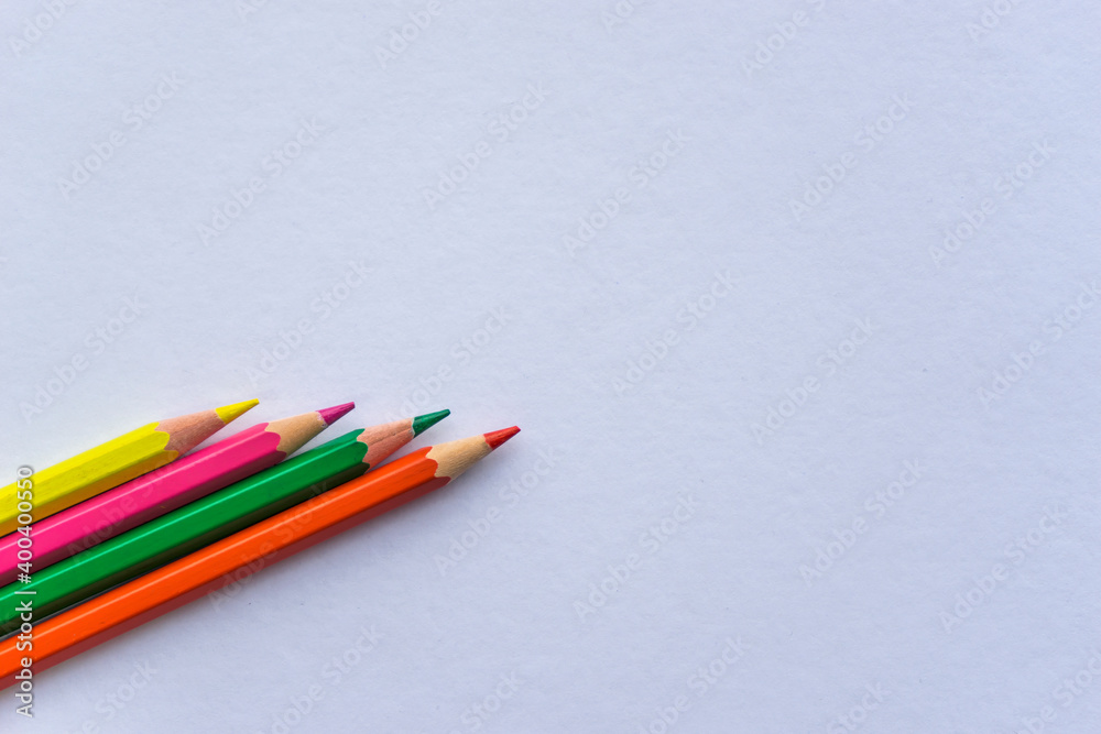 Coloring wooden pencil isolated on white background. Space for text. Colored pencils standing next to each other. Colored paints for drawing pictures. Top view. Coloring wooden pencil isolated on white background. Space for text. Colored pencils standing next to each other. Colored paints for drawing pictures. Top view.