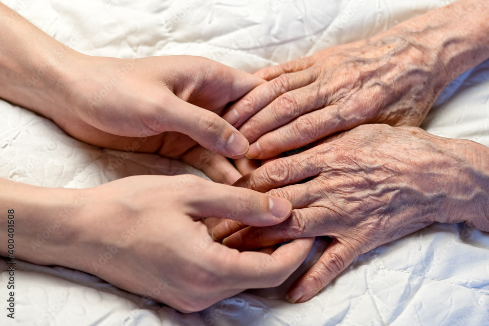 Old and young hands. Hands of an old woman-82 years in the young hands of a grandson. Old and young hands. Hands of an old woman-82 years in the young hands of a grandson.
