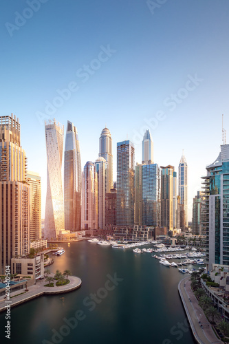 Cityscape and skyscraper at sunrise in Dubai Marina.