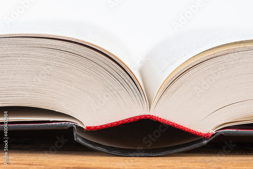 Macro of open book on wooden table