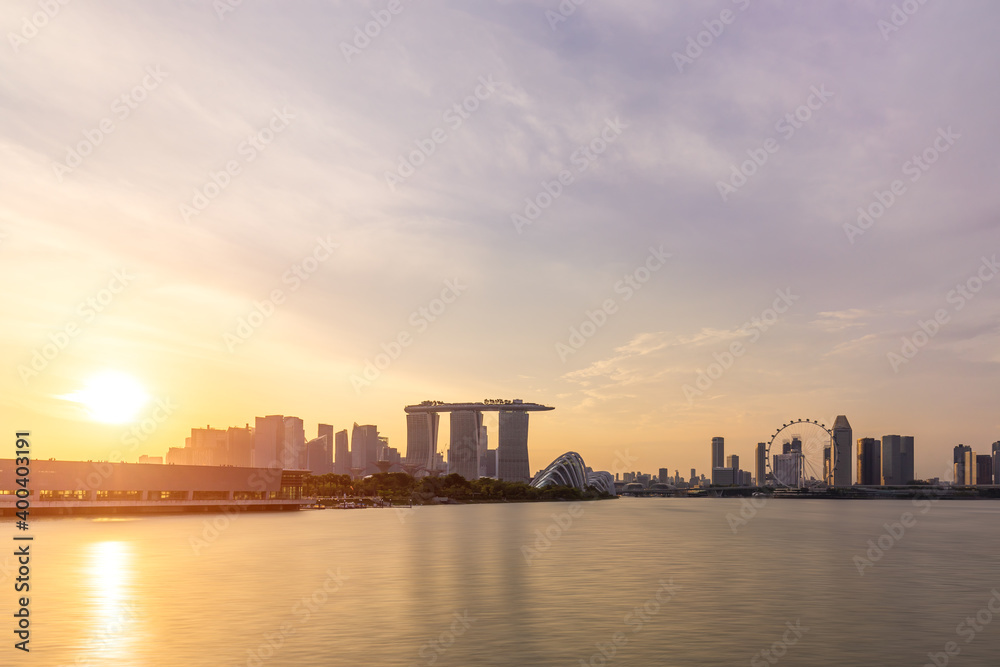 Panoramic views of urban skyline and cityscape at sunset in Singapore.