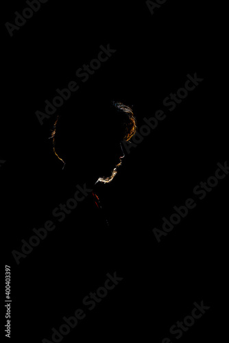 Colored silhouette of a man on dark background.