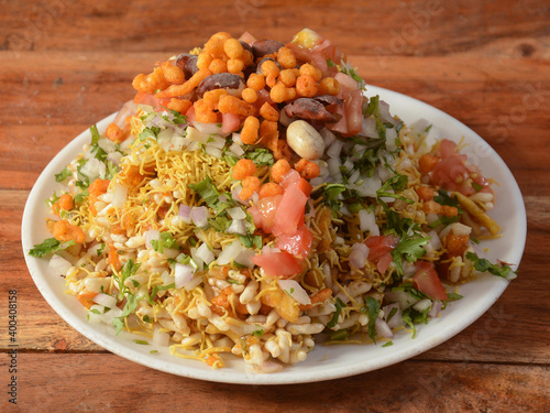 Bhel puri, a famous midday snack in india, served over a rustic wooden background, selective focus