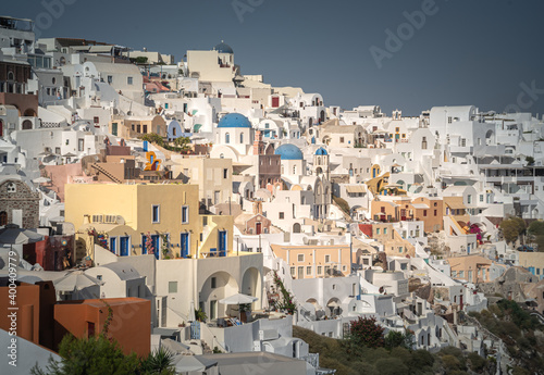 Greece Traveling. View of Greek Traditional Colorful Houses and Windmills of Oia or Ia at Santorini Island in Greece © Mariana Ianovska