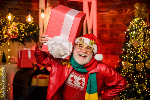 opening a Christmas present. happy new year at home. presents from santa with love. stack gifts under Christmas tree. winter holiday shopping. party celebration. happy man with beard. xmas decoration