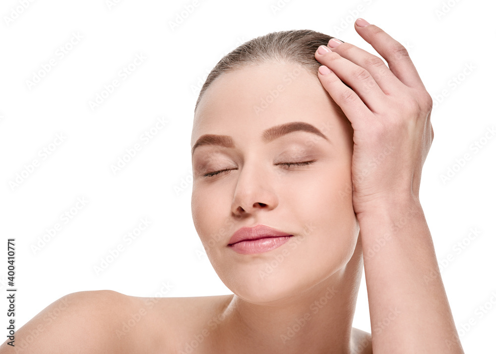 Young smiling woman touching perfect smooth face skin on white Young smiling woman touching perfect smooth face skin on white