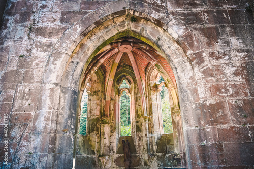 Part of the All Saints abbey ruins in the Black Forest near Oppenau, Germany on a sunny day. A statue of the Virgin Mary is in the center. photo