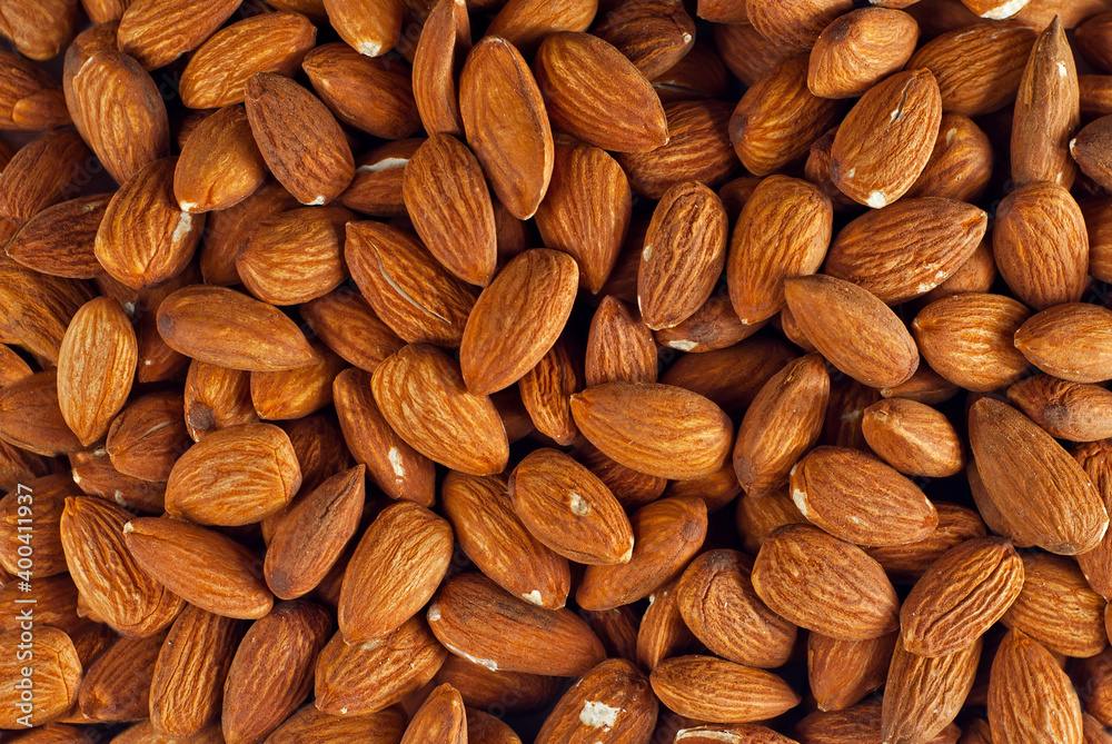 Almonds close up. Texture of nuts. Lots of nuts in a pile. Almonds close up. Texture of nuts. Lots of nuts in a pile.