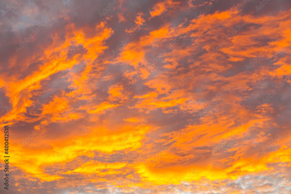 Abstract beautiful orange fluffy clouds on sunrise sky - colorful nature sky texture background