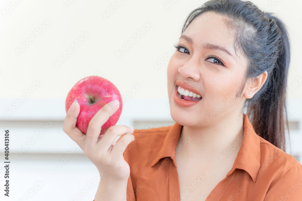 Overweight asian plump female with apple - lifestyle Woman diet weight loss overweight problem concept Overweight asian plump female with apple - lifestyle Woman diet weight loss overweight problem concept