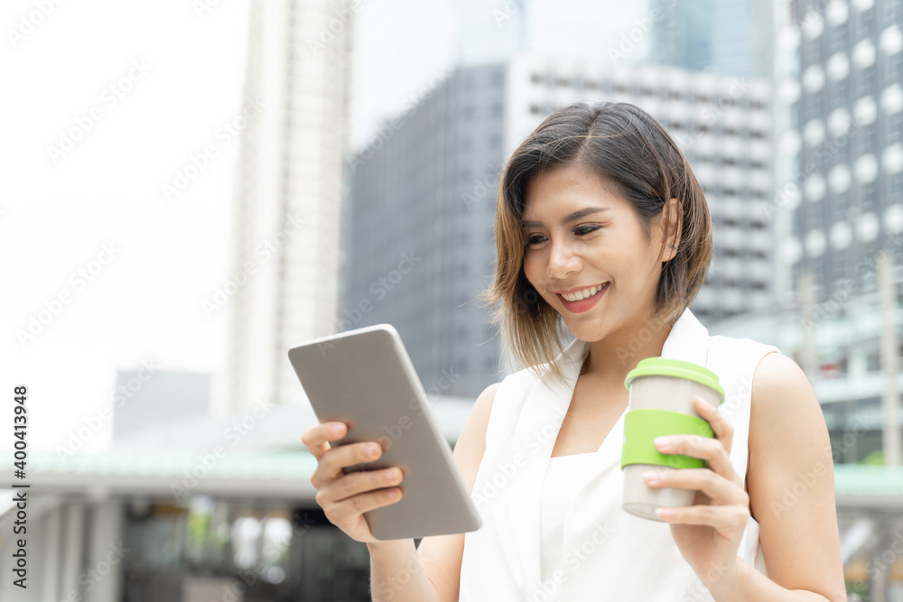 Successful beautiful asian business young woman using smart phone and coffee cup in hand , business concept Successful beautiful asian business young woman using smart phone and coffee cup in hand , business concept