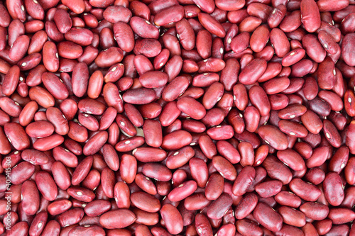 Top view of a thick layer of red beans laid out on a horizontal surface.