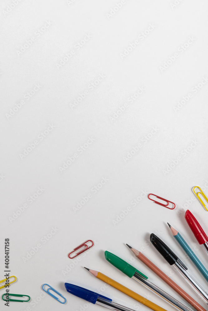 colored kardashi pens paper clips on a white background in the corner colored kardashi pens paper clips on a white background in the corner